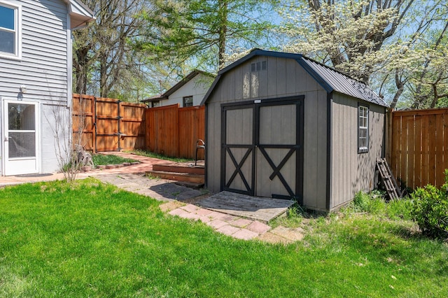 view of shed with a fenced backyard
