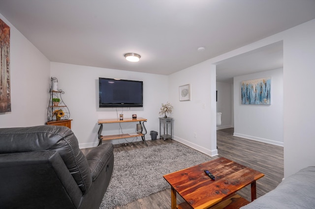 living area featuring wood finished floors and baseboards