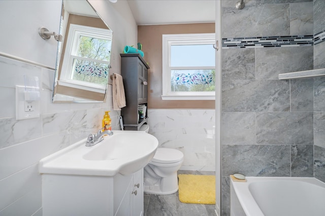full bath featuring vanity, tile walls, and toilet