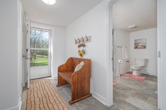 interior space featuring stone finish flooring and baseboards