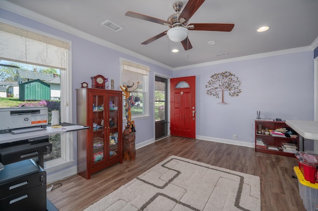 office area featuring baseboards, a ceiling fan, crown molding, visible vents, and wood finished floors