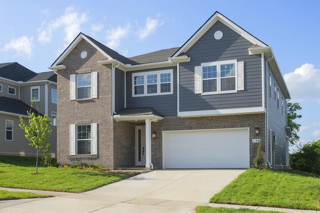 traditional-style house with an attached garage, concrete driveway, a front yard, and brick siding