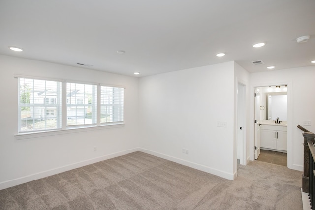 empty room with recessed lighting, a wealth of natural light, light carpet, and visible vents
