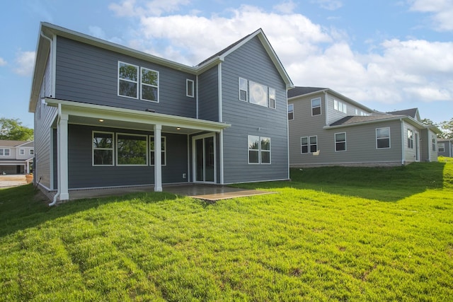 back of property featuring a lawn and a patio