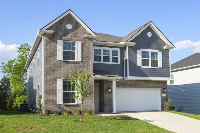 traditional-style home with brick siding, a garage, a front lawn, and driveway