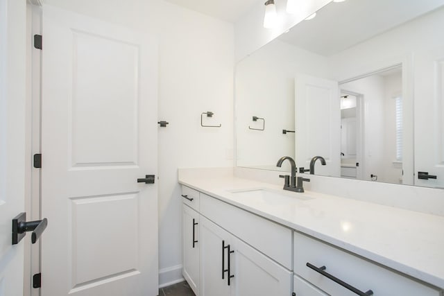 bathroom featuring baseboards and vanity