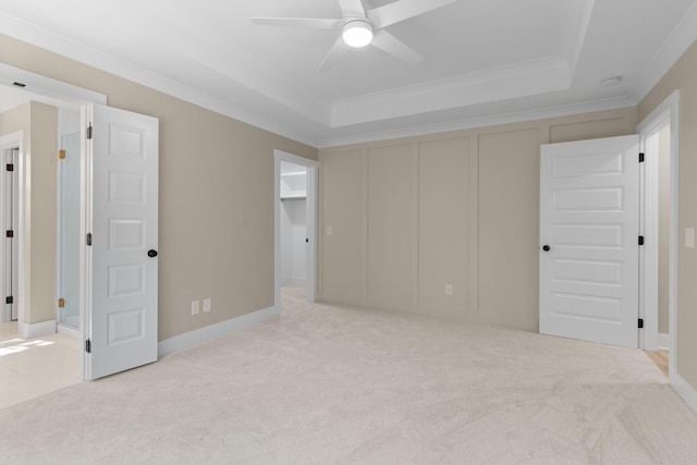 6149 Dewey Carr Rd, Bethpage, TN 37022 - unfurnished bedroom featuring a tray ceiling, light colored carpet, crown molding, a closet, and ceiling fan