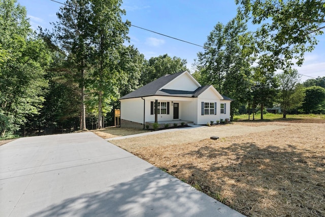 6149 Dewey Carr Rd, Bethpage, TN 37022 - view of front of house featuring driveway, view of wooded area, and roof with shingles