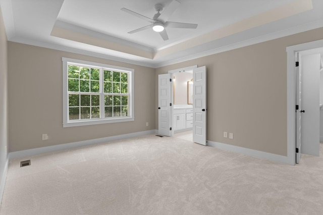 6149 Dewey Carr Rd, Bethpage, TN 37022 - unfurnished bedroom with a tray ceiling, carpet flooring, crown molding, ensuite bathroom, and a walk in closet