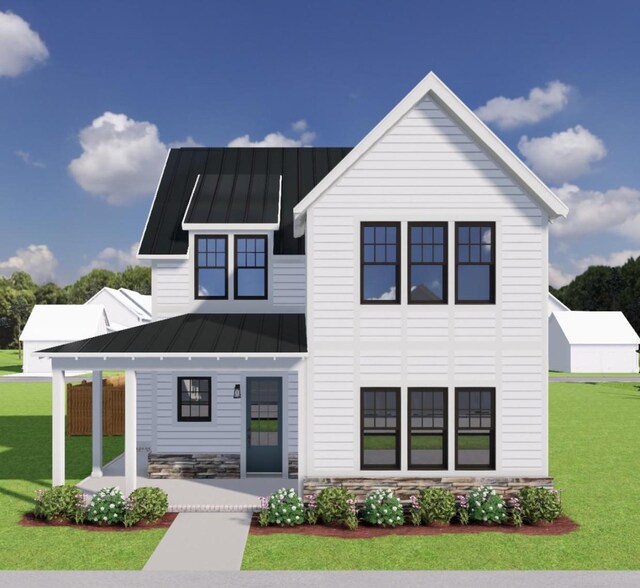modern farmhouse style home featuring a standing seam roof, metal roof, stone siding, and a front lawn