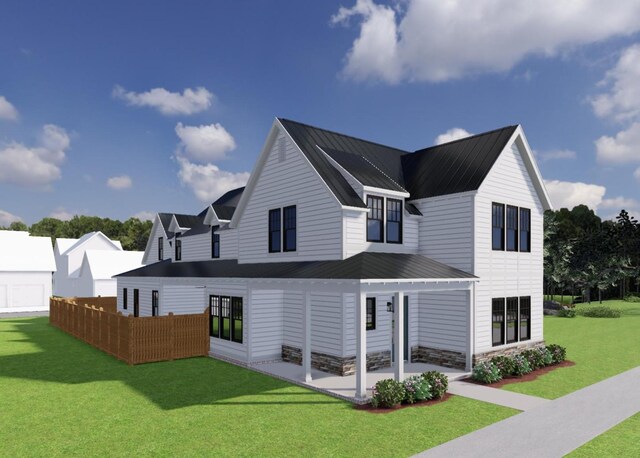 back of house with fence, a standing seam roof, a patio area, metal roof, and a lawn