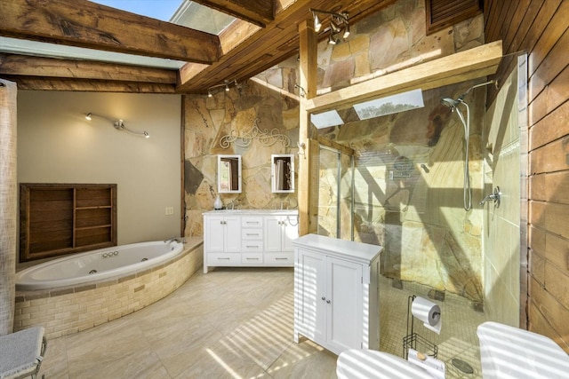 bathroom featuring beamed ceiling, a jetted tub, a stall shower, and vanity
