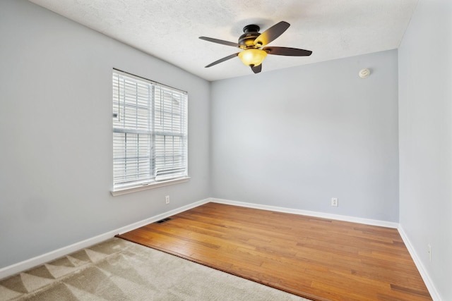 3227 Gardendale Dr, Franklin, TN 37064 - empty room with wood finished floors, visible vents, a ceiling fan, and baseboards
