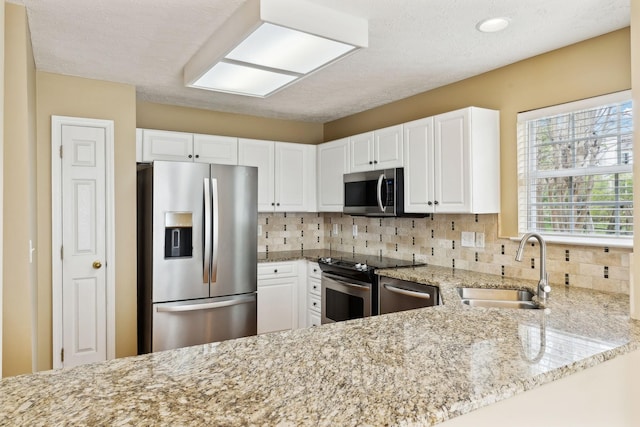 3227 Gardendale Dr, Franklin, TN 37064 - kitchen featuring stainless steel appliances, a sink, backsplash, and light stone counters