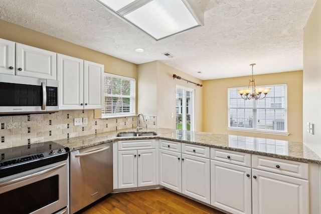 3227 Gardendale Dr, Franklin, TN 37064 - kitchen with white cabinets, light wood-style flooring, stainless steel appliances, and a sink