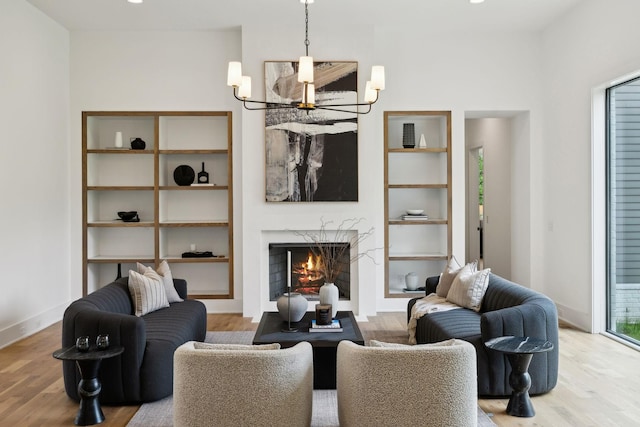 6004 Jocelyn Hollow Rd, Nashville, TN 37205 - living room featuring built in shelves, baseboards, wood finished floors, and a fireplace