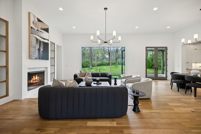 6004 Jocelyn Hollow Rd, Nashville, TN 37205 - living room with a glass covered fireplace, recessed lighting, an inviting chandelier, and wood finished floors