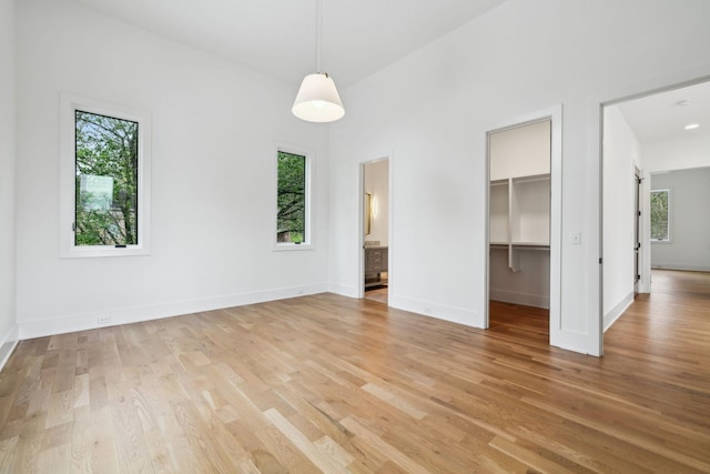 6004 Jocelyn Hollow Rd, Nashville, TN 37205 - unfurnished bedroom featuring a spacious closet, multiple windows, and light wood-style floors