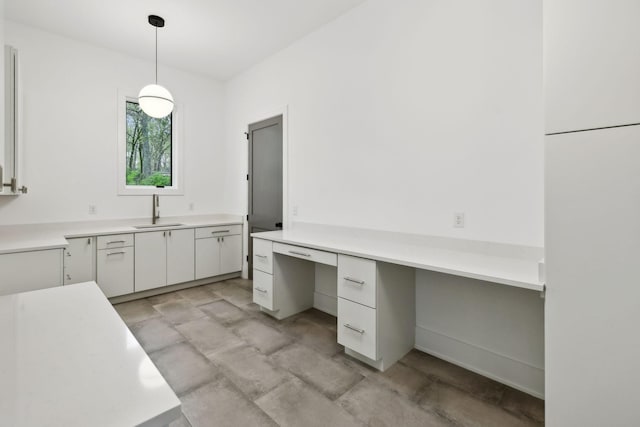 6004 Jocelyn Hollow Rd, Nashville, TN 37205 - kitchen featuring white cabinets, pendant lighting, light countertops, and a sink