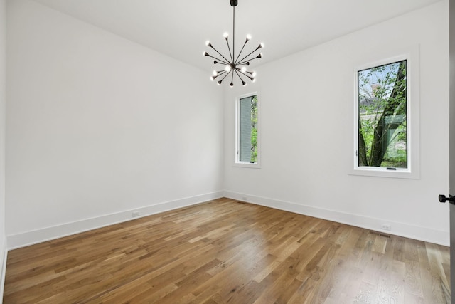 6004 Jocelyn Hollow Rd, Nashville, TN 37205 - empty room featuring baseboards, light wood finished floors, plenty of natural light, and a chandelier
