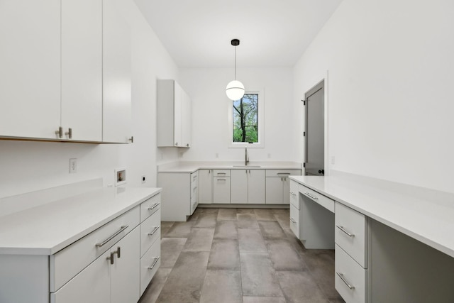 6004 Jocelyn Hollow Rd, Nashville, TN 37205 - kitchen with white cabinets, light countertops, a sink, and hanging light fixtures