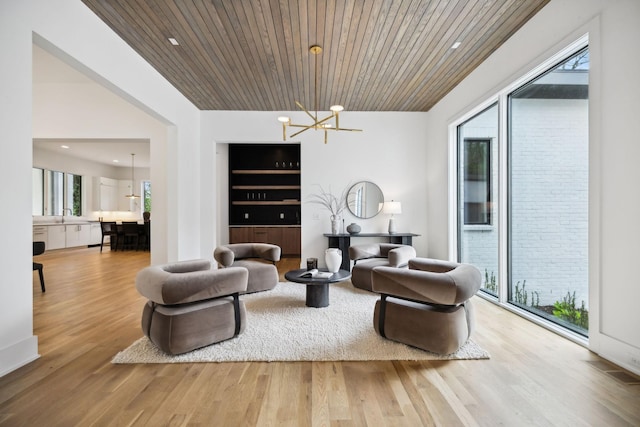 6004 Jocelyn Hollow Rd, Nashville, TN 37205 - living room with a healthy amount of sunlight, an inviting chandelier, and wood finished floors