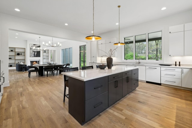 6004 Jocelyn Hollow Rd, Nashville, TN 37205 - kitchen featuring modern cabinets, light wood-style flooring, white cabinets, dishwasher, and a sink