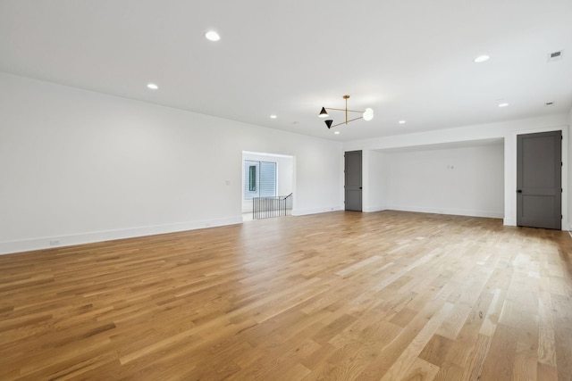 6004 Jocelyn Hollow Rd, Nashville, TN 37205 - unfurnished living room featuring light wood-style floors, baseboards, visible vents, and recessed lighting