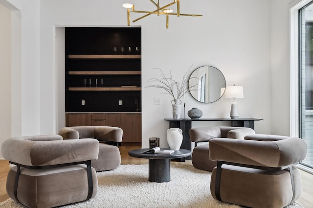6004 Jocelyn Hollow Rd, Nashville, TN 37205 - sitting room featuring wood finished floors, a notable chandelier, and built in shelves