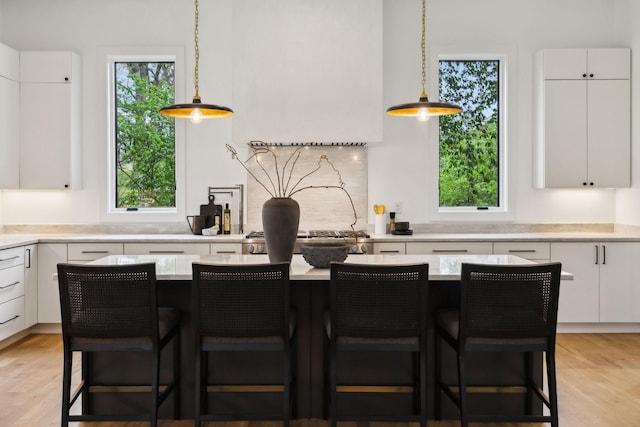 6004 Jocelyn Hollow Rd, Nashville, TN 37205 - kitchen featuring decorative light fixtures, light wood-style floors, light countertops, and white cabinetry