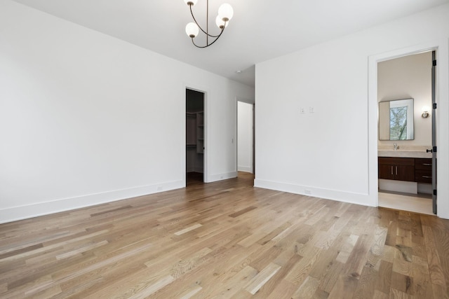 6004 Jocelyn Hollow Rd, Nashville, TN 37205 - interior space featuring a sink, light wood-style flooring, a notable chandelier, and baseboards