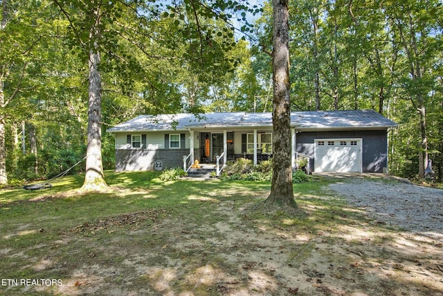3115 Coon Hunter Lodge Rd, Jamestown, TN 38556 - ranch-style home featuring an attached garage, gravel driveway, and covered porch