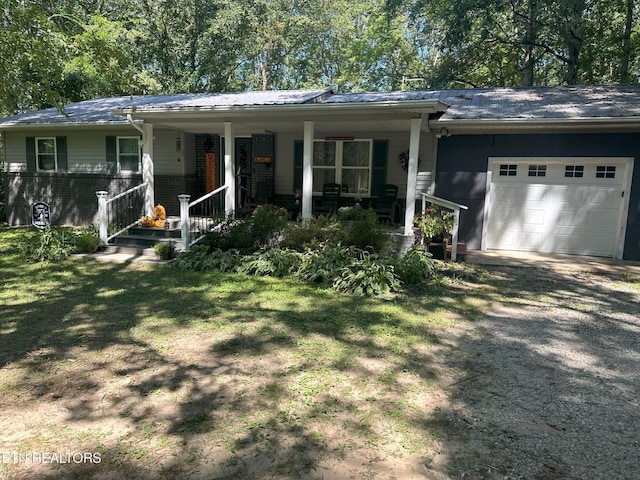 3115 Coon Hunter Lodge Rd, Jamestown, TN 38556 - ranch-style home with an attached garage, driveway, covered porch, brick siding, and a front yard