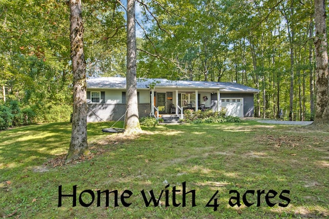 3115 Coon Hunter Lodge Rd, Jamestown, TN 38556 - ranch-style home with covered porch, a front yard, and an attached garage