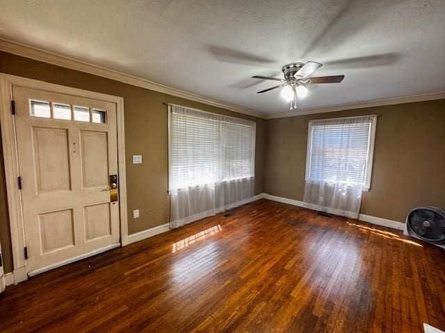foyer entrance featuring crown molding, baseboards, a ceiling fan, and hardwood / wood-style flooring