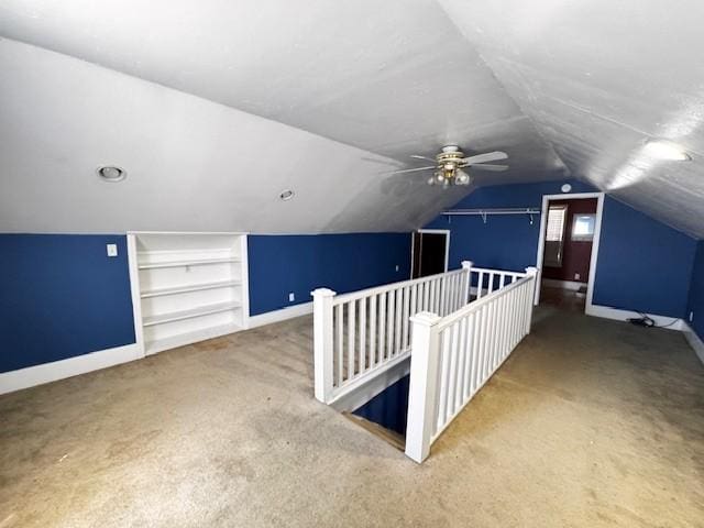 additional living space with carpet flooring, baseboards, and built in features