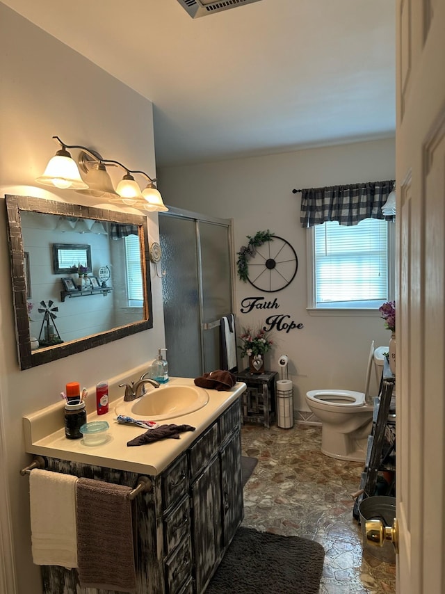 2901 Hurricane Creek Rd, Lawrenceburg, TN 38464 - bathroom featuring a shower stall, stone finish floor, visible vents, toilet, and vanity