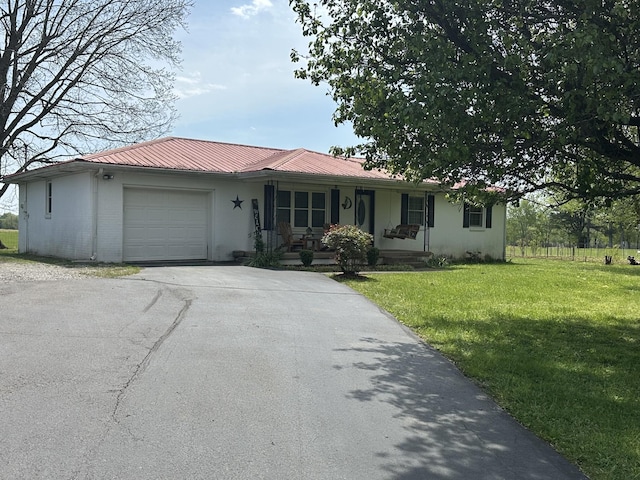 2901 Hurricane Creek Rd, Lawrenceburg, TN 38464 - single story home with a front lawn, driveway, covered porch, an attached garage, and metal roof