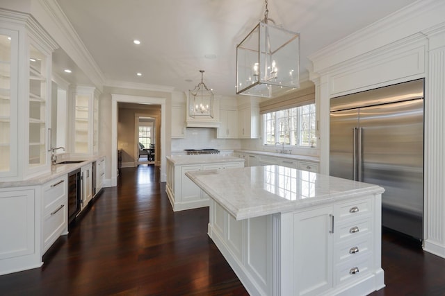 6021 Jocelyn Hollow Rd, Nashville, TN 37205 - kitchen featuring built in refrigerator, a wealth of natural light, a kitchen island, and a chandelier