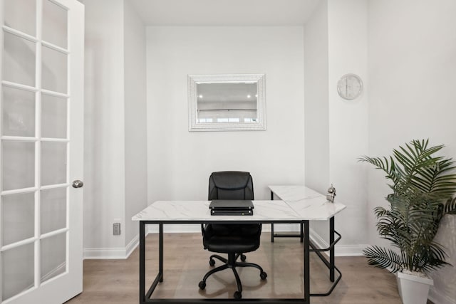 office area featuring baseboards and wood finished floors