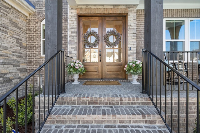doorway to property featuring french doors and brick siding