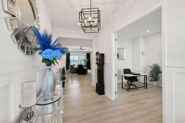 foyer featuring crown molding, recessed lighting, an inviting chandelier, and light wood finished floors