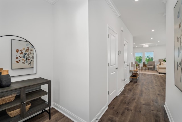 hall featuring recessed lighting, baseboards, crown molding, and dark wood finished floors