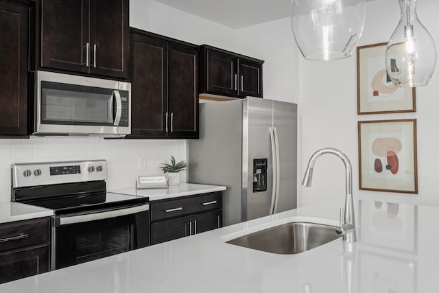 kitchen featuring light countertops, a sink, and stainless steel appliances