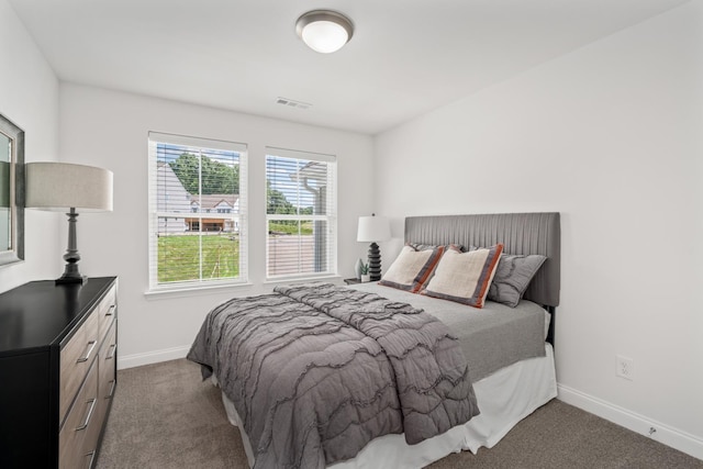 carpeted bedroom with visible vents and baseboards