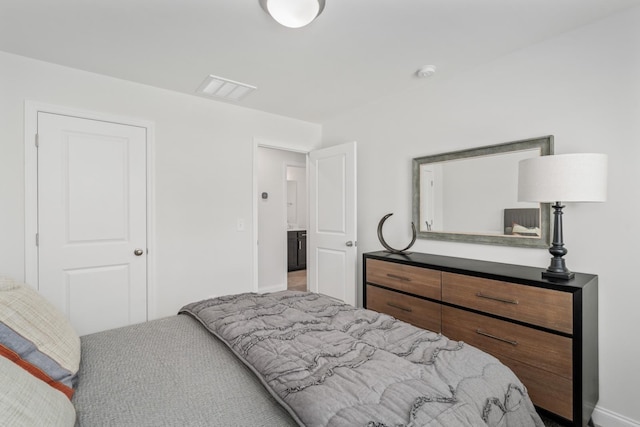 bedroom with visible vents and baseboards
