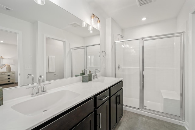 bathroom featuring a shower stall, a sink, and visible vents