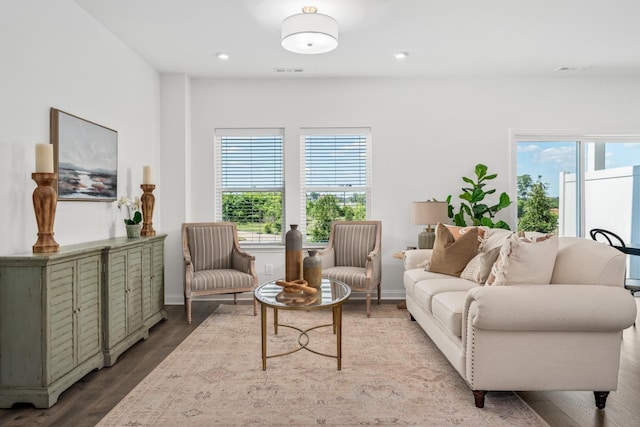 living room featuring recessed lighting, plenty of natural light, visible vents, and wood finished floors