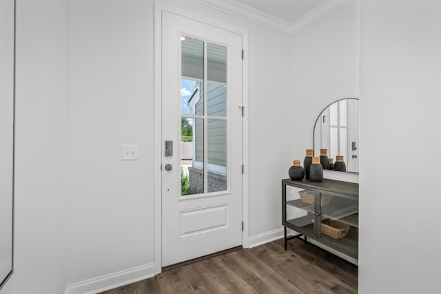 doorway with dark wood-style flooring, baseboards, and ornamental molding