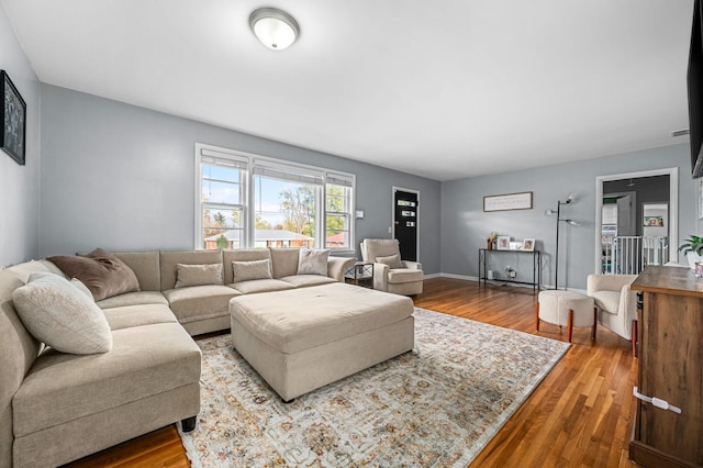 living room with baseboards and wood finished floors